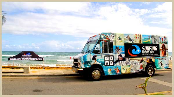 surfing in puerto rico van truck parked at La Pared Beach in Luquillo, Puerto Rico, ready for surfing lessons puerto rico and surf rentals puerto rico