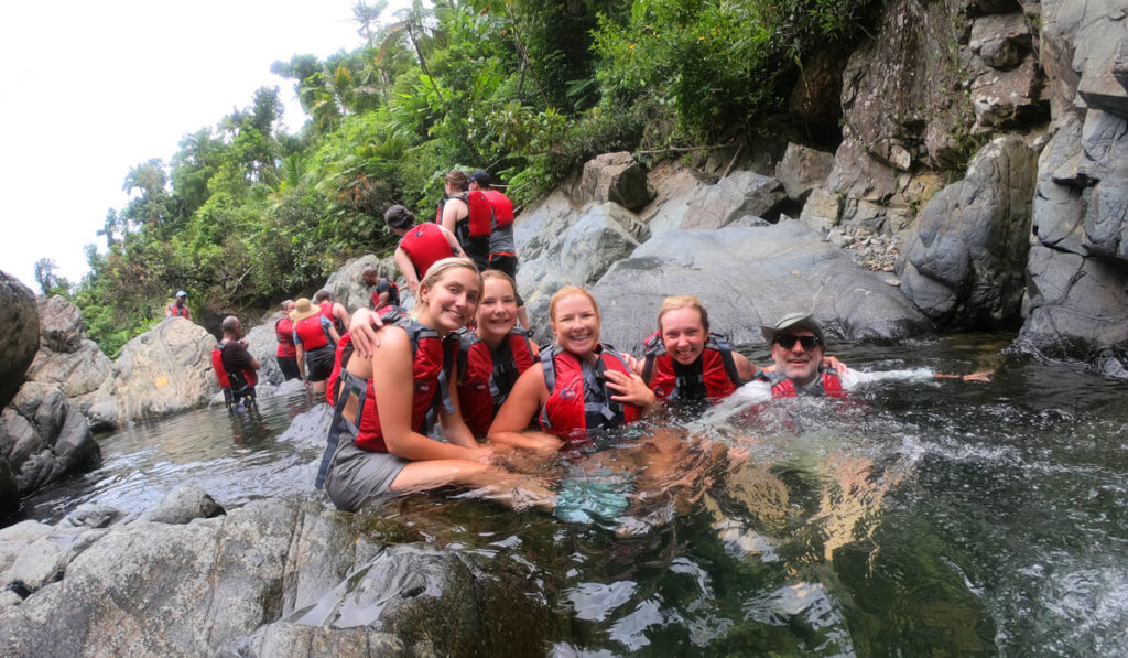 A group of people having fun in El Yunque river