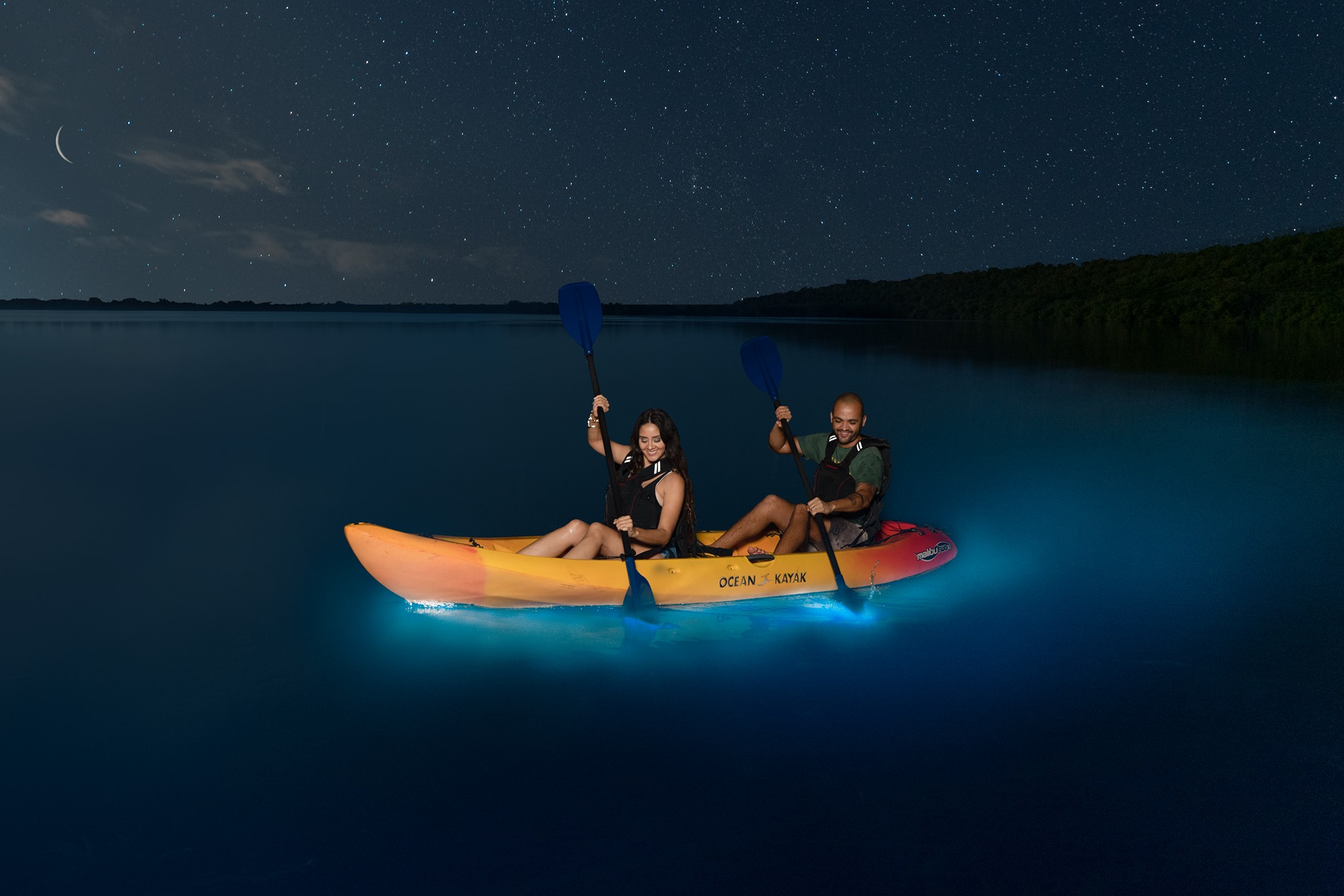 A couple kayaking in the bioluminescent bay